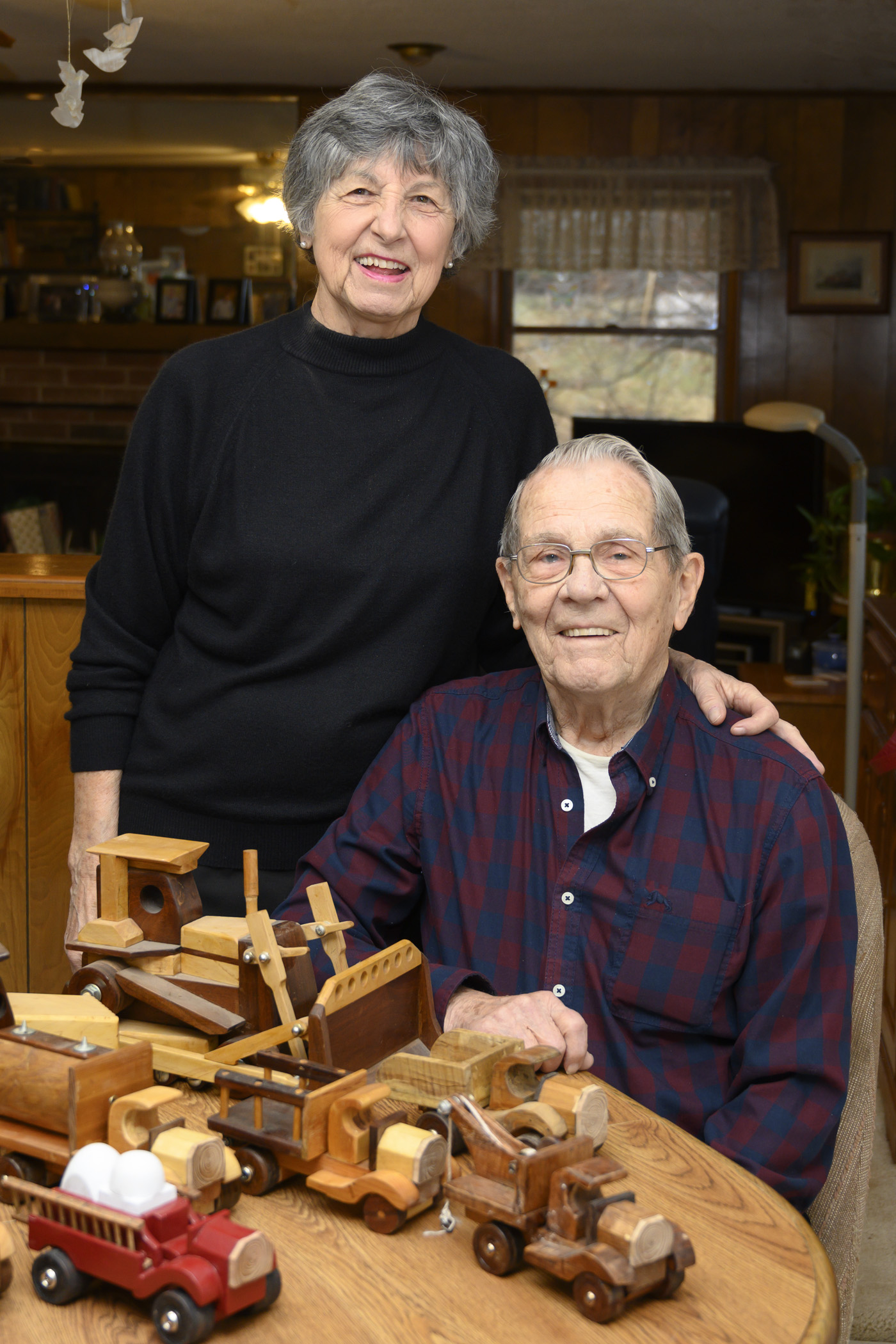 Carl and his wife, Vonnie, with his wooden toy trucks
