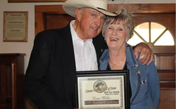 Duane and his wife, Jo, holding an award