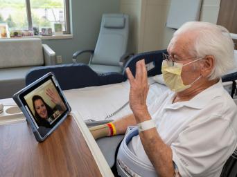 Don, a patient at Saint Luke's, connects with his daughter, Deb, on an iPad since she can't visit him in the hospital due to COVID-19.