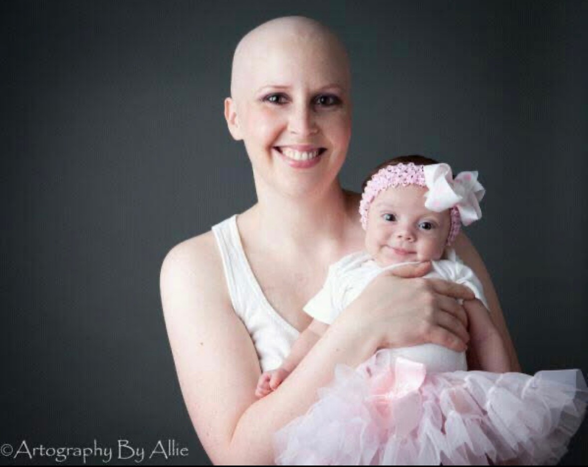Kelly, a breast cancer patient, is show in a portrait with her young child.