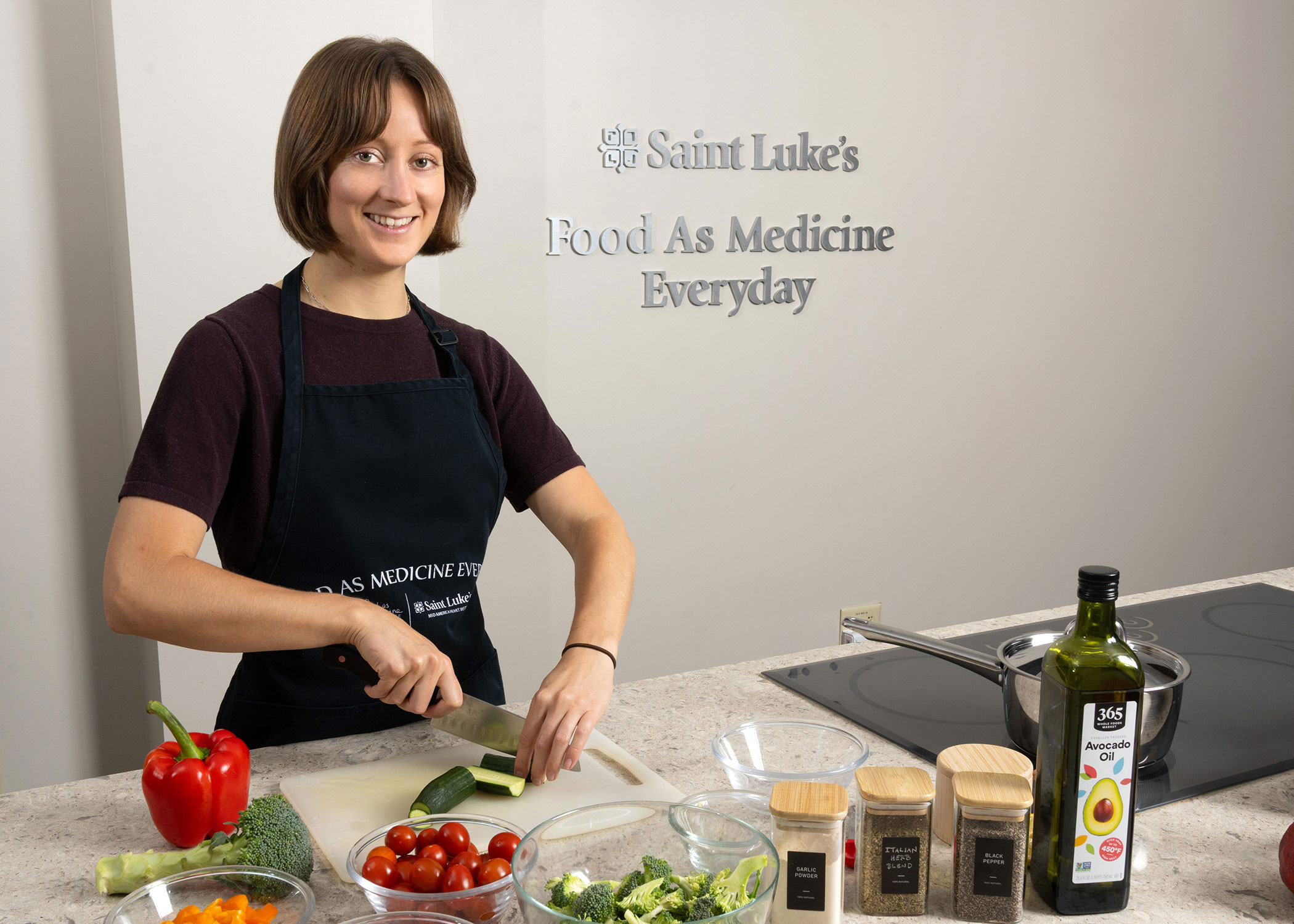 Morgan Murphy, a team member at Food As Medicine Everyday, is preparing a meal.