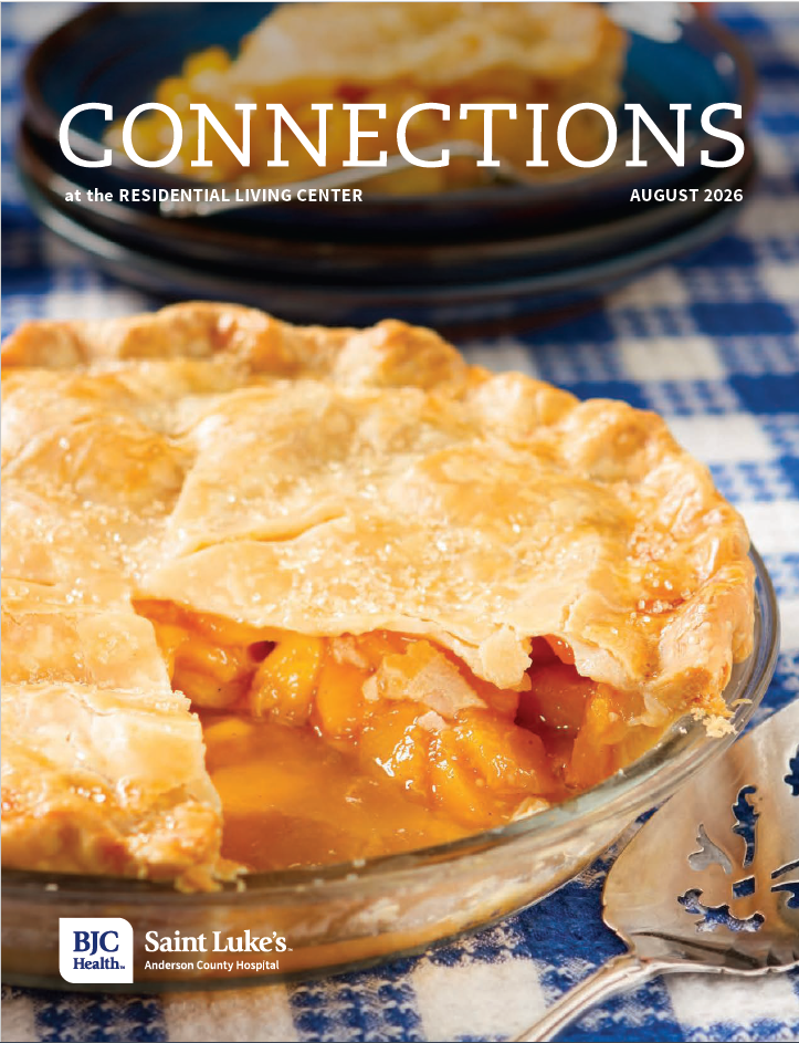 Peach pie with a piece of pie missing on a blue and white checkered table cloth. 