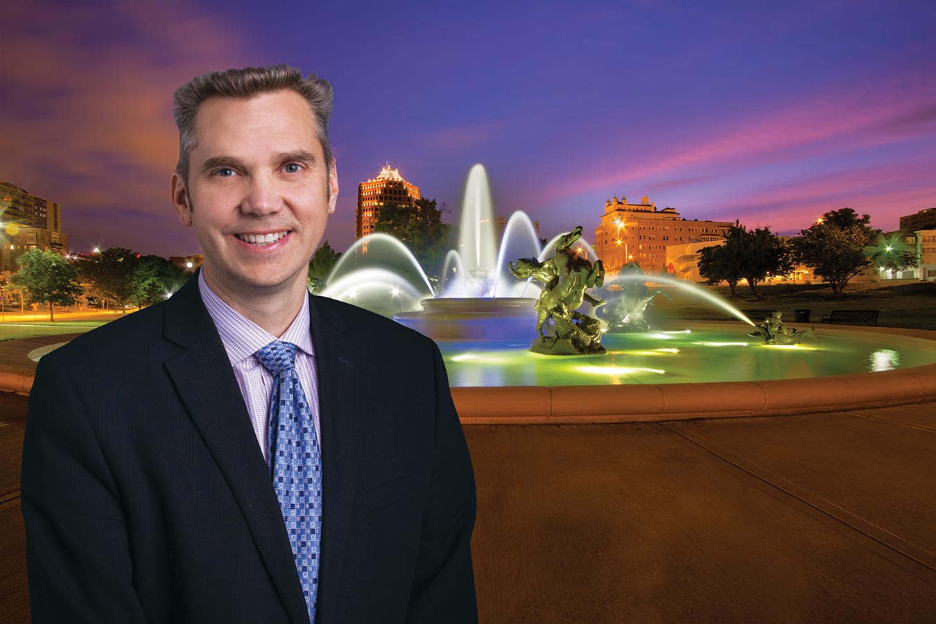 Joel DeBoer poses beside Kansas City's Country Club Plaza fountain