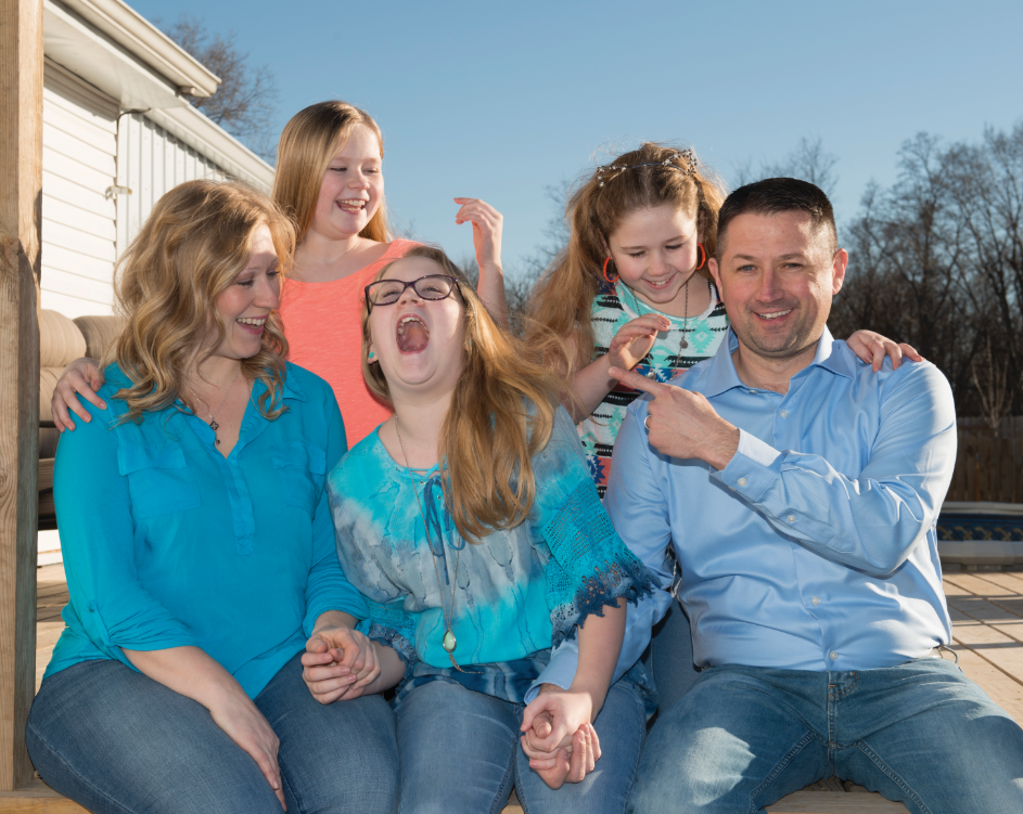Kidney Transplant family laughs as their photo is taken