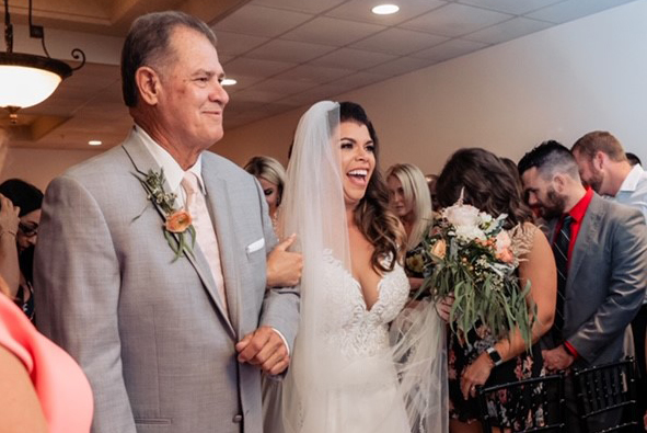 Henry Myers walking his daughter down the aisle.