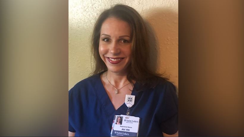Abi Sutton, RN, in her blue scrubs