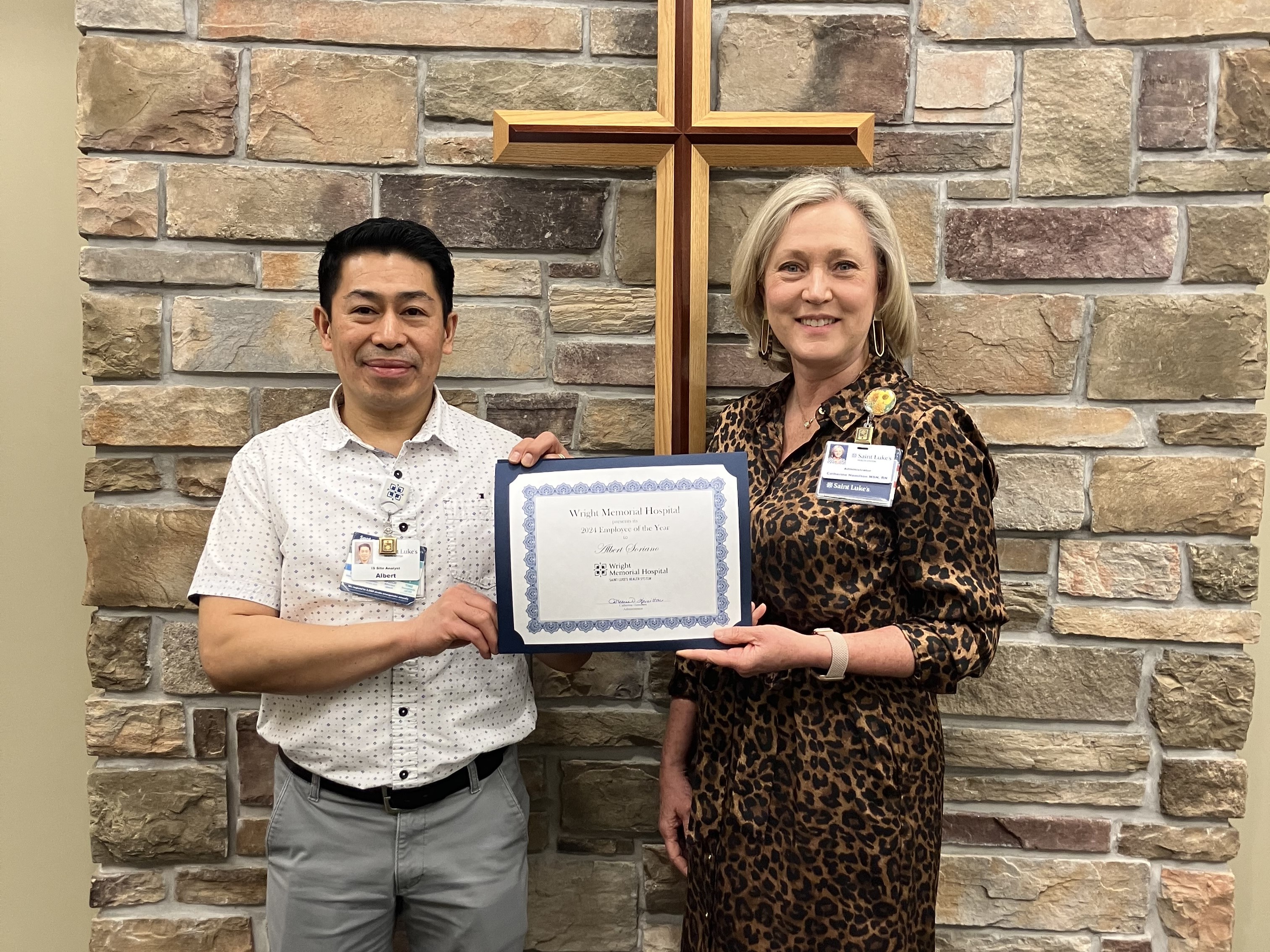 Albert Soriano (left) receives 2024 Wright Memorial Hospital Employee of the Year Award from administrator Catherine Hamilton.