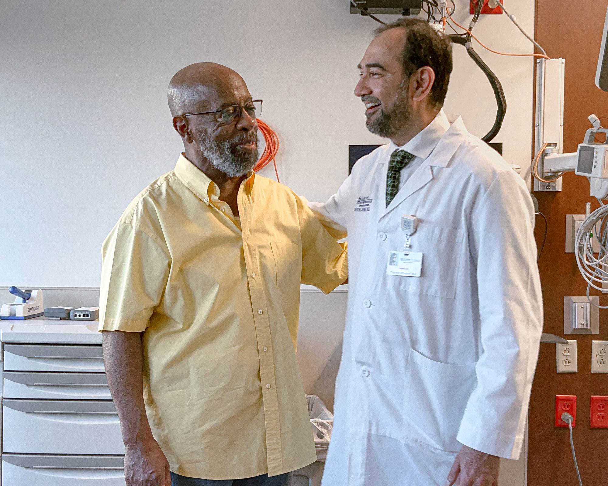Anthony, a Saint Luke's heart transpant patient, is smiling with Dr. Khumri, a Saint Luke's cardiologist.