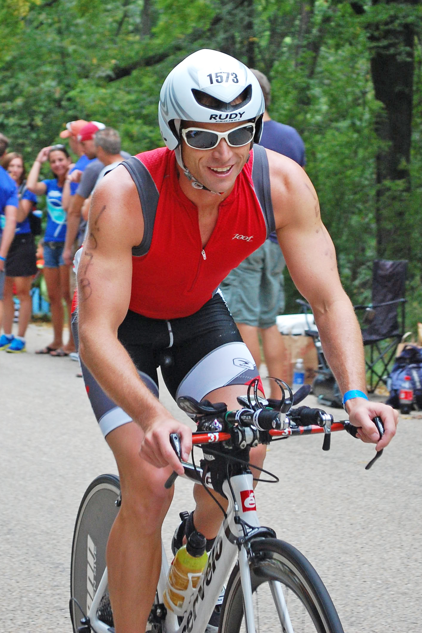 Clark is riding his bicycle in full racing gear.