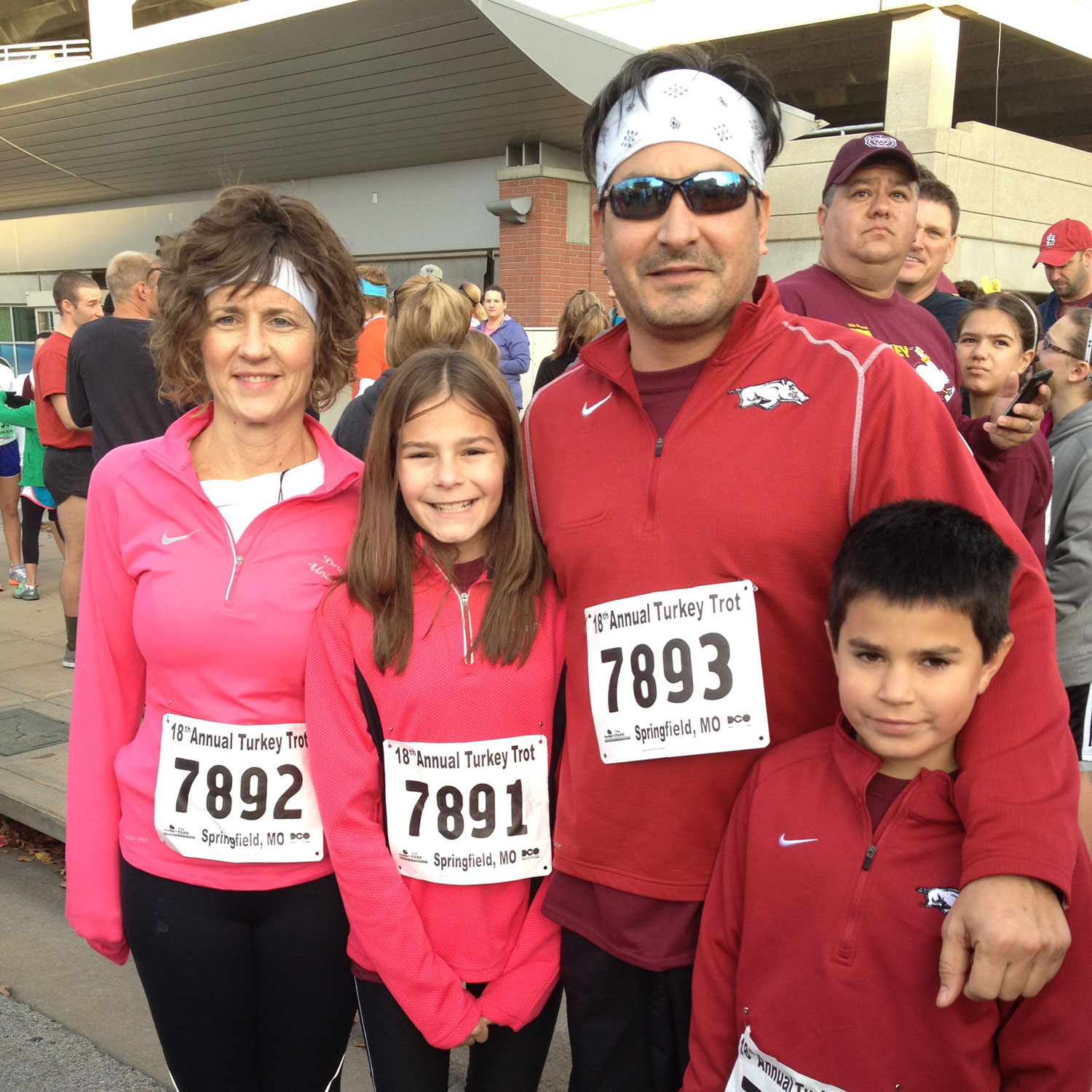 David, a heart transplant patient, is hugging his family in running attire.
