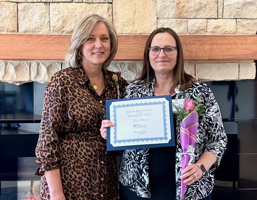 Terry Plaster receiving award for employee of the year from Catherine Hamilton.