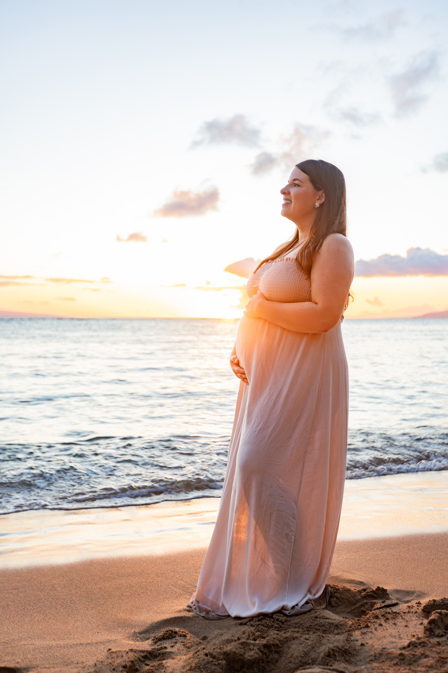 32 year old Katie Pinkgham in pink maternity gown overlooking the beach
