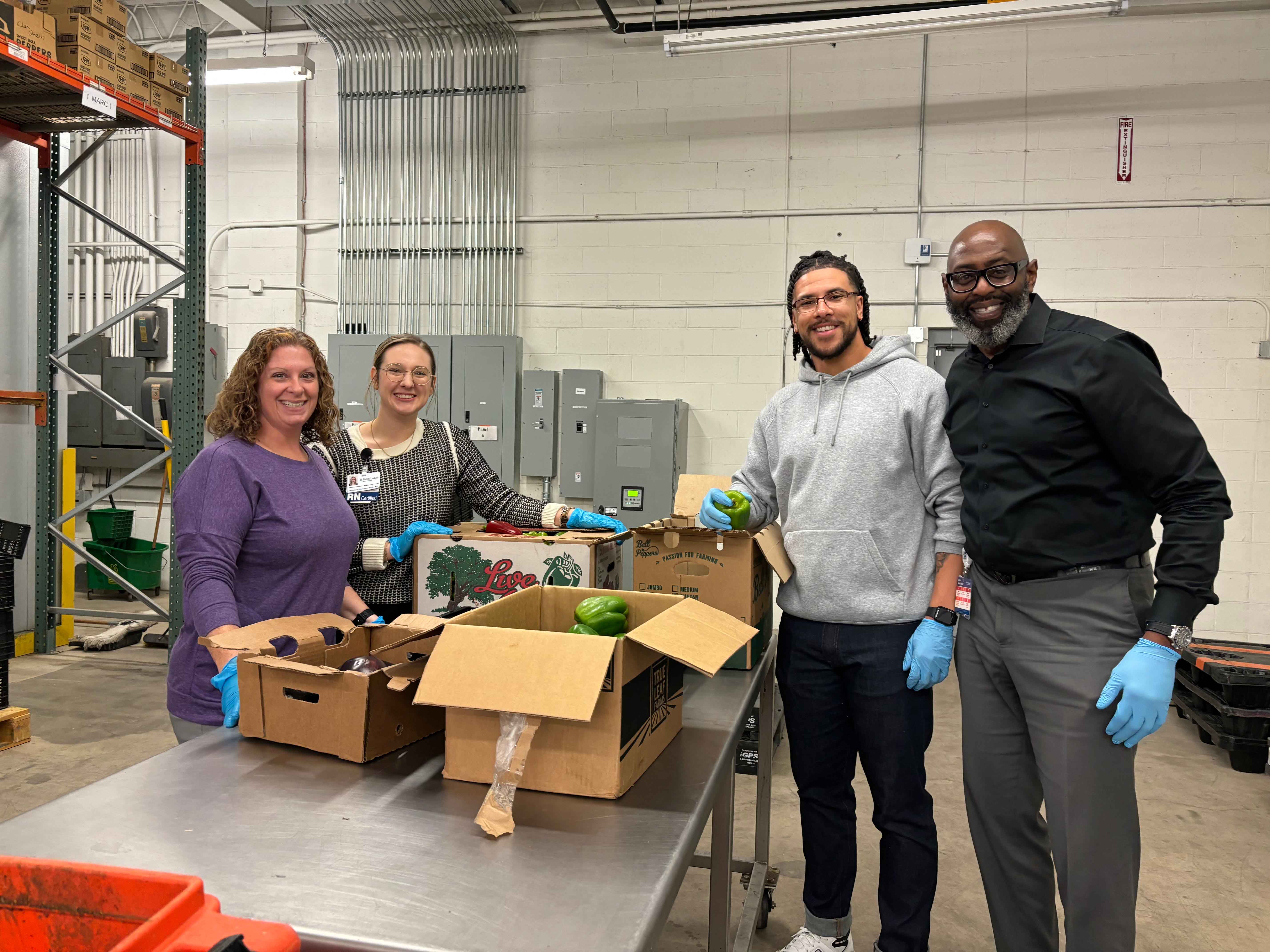 Saint Luke’s Population Health Team members volunteer at Kanbe’s Markets; sorting produce sent to area corner stores so that people in Kansas City’s underserved communities can access healthy, fresh foods.