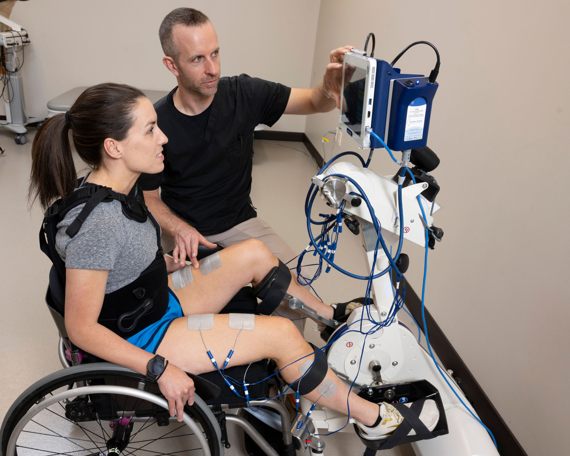 Patient participates in stationary bike stimulation therapy