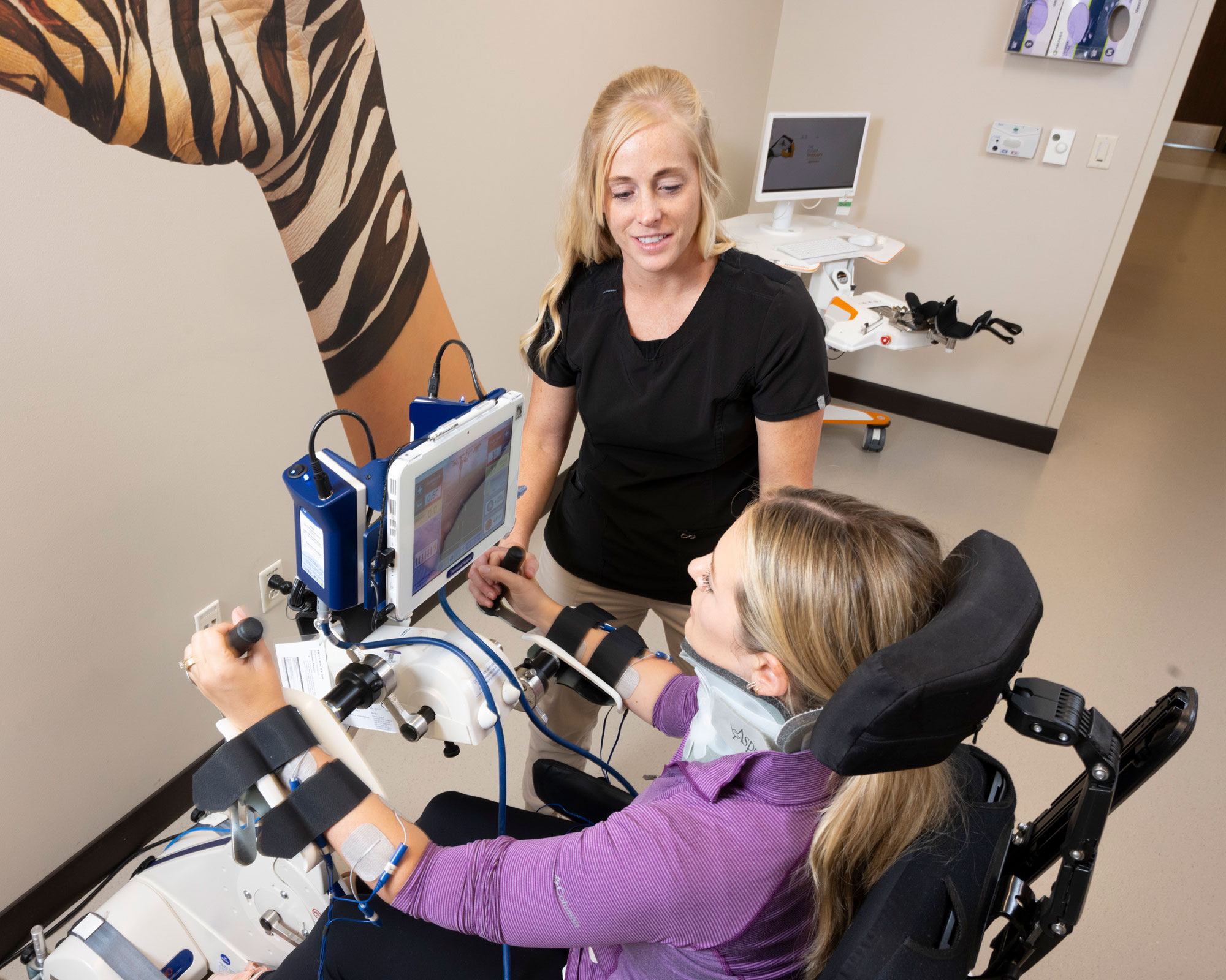 Patient observes screen during upper extremity cycling therapy