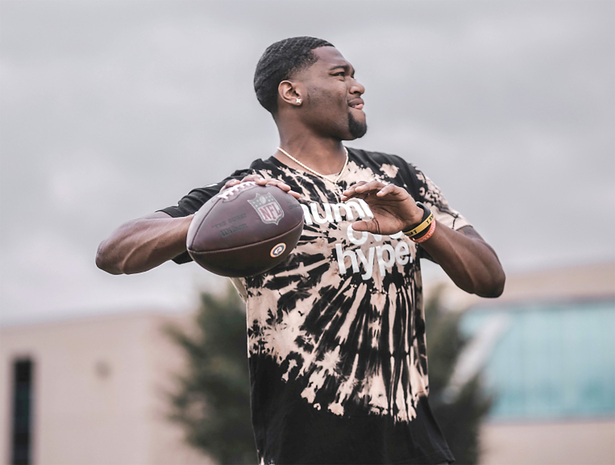 Pro FB quarterback throwing football